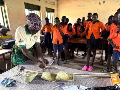 A community expert demonstrates how to weave baskets from African Fan Palm leaves