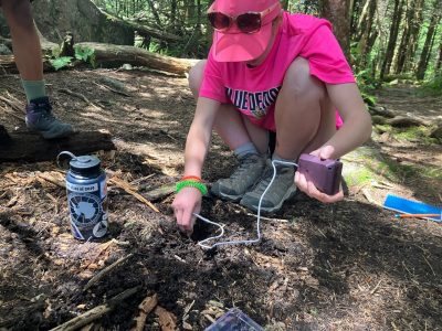 Student testing the pH of soil on Mt. Rogers.