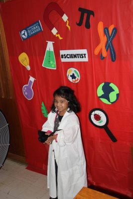 Young child in lab coat dressed like a scientist. 