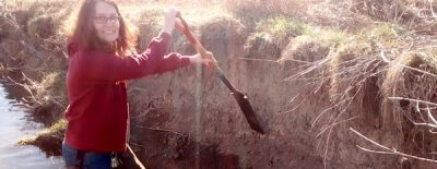 Heather Govenor with shovel at Stroubles Creek