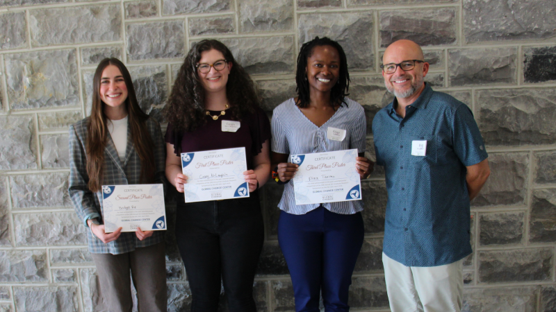 IGC IGEP Director Dr. Bill Hopkins stands with poster award winners Bridget Re, Casey McLaughlin, and Eliza Tarimo.