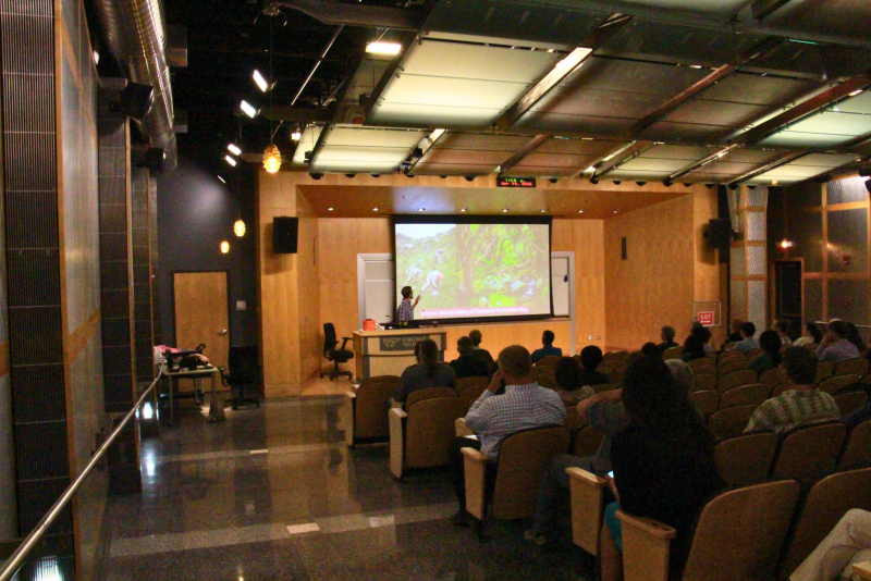 Attendees seated in front row of Steger Auditorium listen intently during talks.
